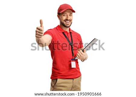 Male shop assistant gesturing a thumb up sign isolated on white background Royalty-Free Stock Photo #1950901666