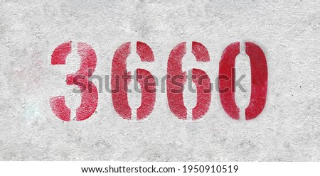 Red Number 3660 on the white wall. Spray paint.