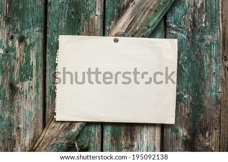 white paper page booklet on worn plank door - place of the message