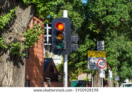 The traffic signal with the red light on at the side of Melbourne's urban street.  VIC Australia.