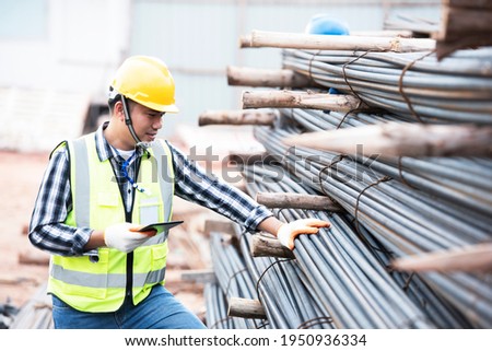 Inspectors are inspecting rebars at a construction site for rebar or reinforcement. Royalty-Free Stock Photo #1950936334
