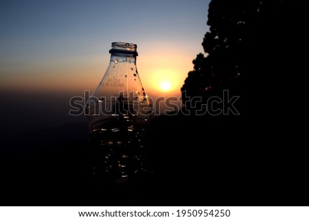Beautiful picture of water bottle and sunset in background , Water drops. Selective Focus On Subject