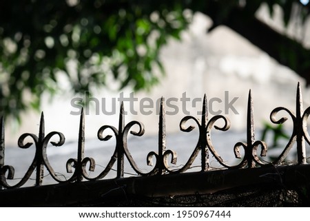 Part of the fence with a metal spike to prevent thieves.