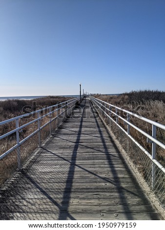 wooden walkway to ocean sandy beach