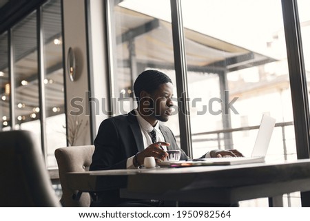 Man sitting at the computer and drinking coffee