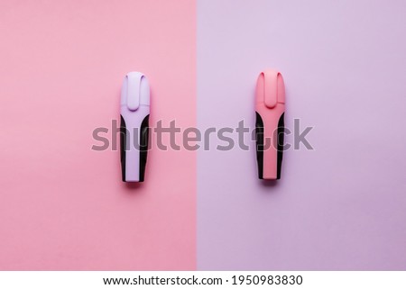 Pink and lilac marker on a colored spring background. Minimalism.