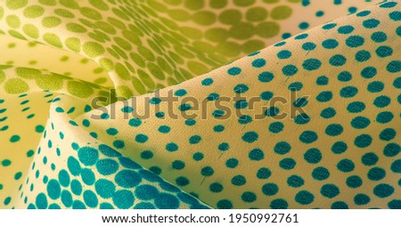 silk fabric. texture or background with cool mint, blue and yellow green polka dot dots on a beige backdrop for web design, desktop wallpaper, winter blog, website or invitation card.