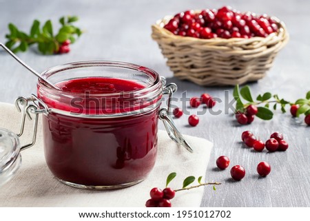 Glass jar with homemade lingonberry sauce. Canning lingonberry sauce Royalty-Free Stock Photo #1951012702
