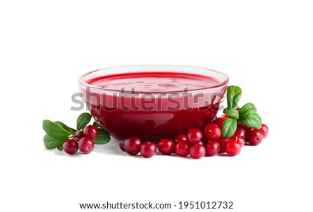 Homemade fresh wild lingonberry sauce in small glass bowl isolated on white background