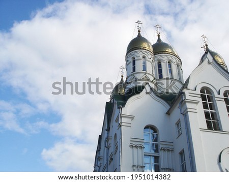horizontal background with white orthodox church of with golden domes and crosses on a background of beautiful blue sky with clouds, Ryazan, Russia 