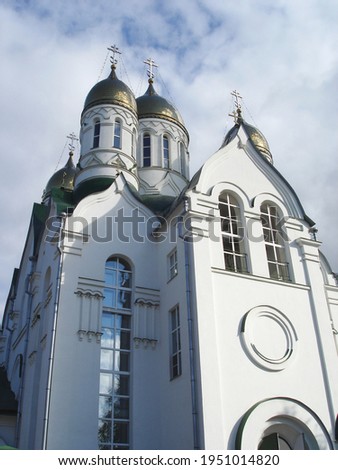 vertical background with white orthodox church of with golden domes and crosses on a background of beautiful blue sky with clouds, Ryazan, Russia 