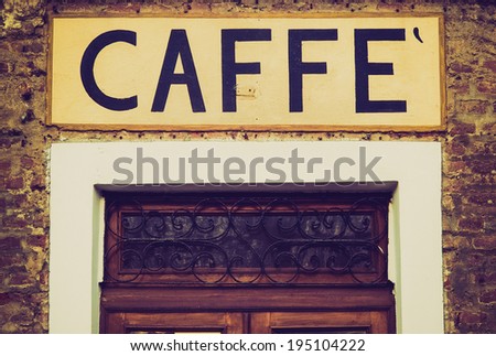 Vintage retro looking An old Caffe (Cafe) sign on a bar door