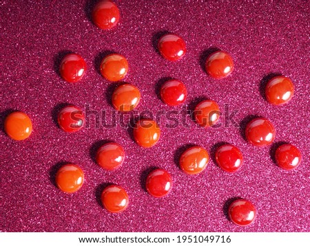 Crimson-red glass beads background - closeup beads texture.