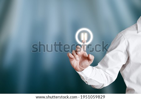 Male hand pressing pause icon on a virtual display screen. Royalty-Free Stock Photo #1951059829