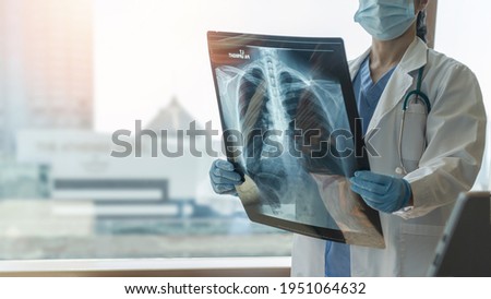 Lung disease, covid-19, asthma or bone cancer illness with doctor diagnosing patient’s health on radiological chest x-ray film for medical healthcare hospital service Royalty-Free Stock Photo #1951064632