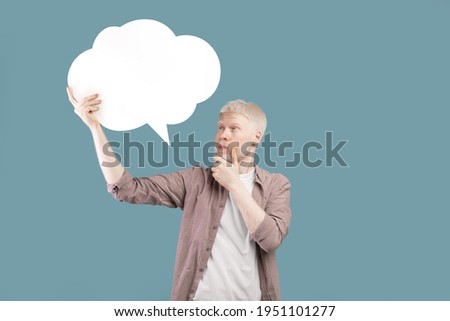Thinking concept. Albino guy with speech bubble deep in thought posing on color background, space for text. Thoughtful man with empty word cloud, mockup for your ad or design