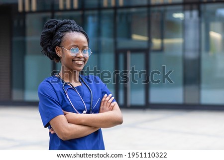 portrait young  black lady doctor with stethoscope with glasses, trendy african american woman with dreadlocks, uniform, smiling afro girl medical student  at college, university, hospital, clinic Royalty-Free Stock Photo #1951110322