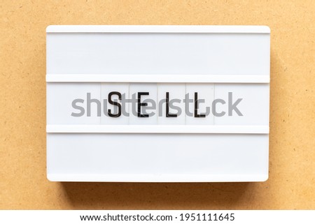 Lightbox with word sell on wood background