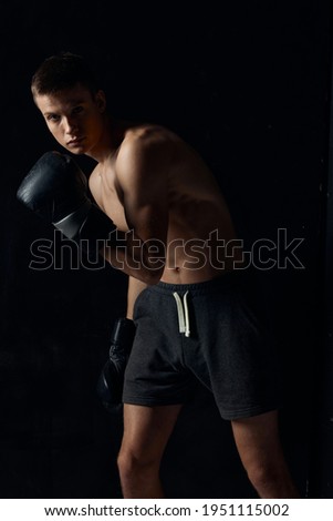 bodybuilder wearing boxing gloves black background cropped view sport fitness