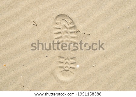 View of a shoe footprint in the sand