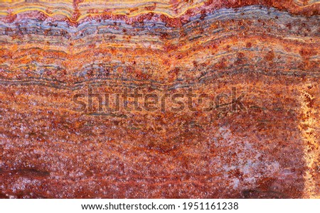 colorful rusty metal surface divided into layers or strata as geological creating organic shapes - worn abstract background for a wallpaper Royalty-Free Stock Photo #1951161238
