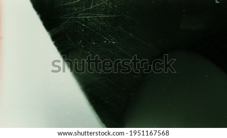 Blank grained toned film strip texture background with heavy grain, dust and light leak