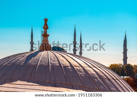 View of the dome of Hagia Sophia and the minarets of the Blue Mosque (Sultan Ahmed Mosque) against the background of a bright blue sky in Istanbul, Turkey