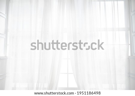 Backlit window with white curtains in empty room Royalty-Free Stock Photo #1951186498
