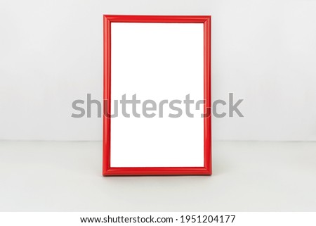 Red vertical frame on table. Isolated white background. Place for your text
