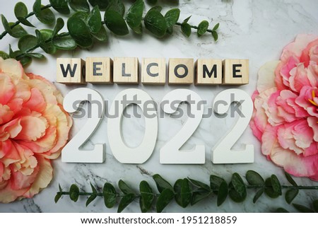 Welcome 2022 alphabet letters on marble background