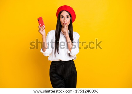 Photo of beautiful stunning gorgeous french woman hold cellphone cover mouth with finger isolated on yellow color background