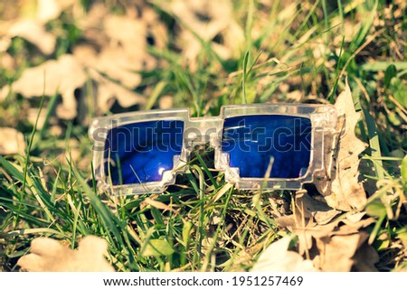 Blue lenses pixel sunglasses model shoot in a summer day closeup. Selective focus
