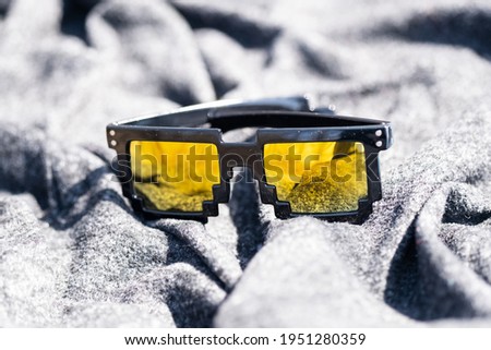 Yellow lenses pixel 8bit sunglasses design shoot in a summer day closeup.Thug life model. Selective focus