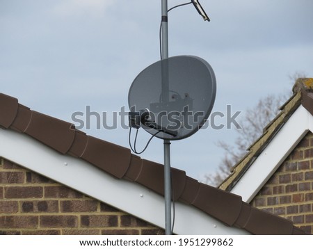 Pole mounted TV satellite dish Royalty-Free Stock Photo #1951299862