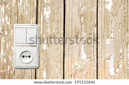 outlet and switch on the background of wooden wall