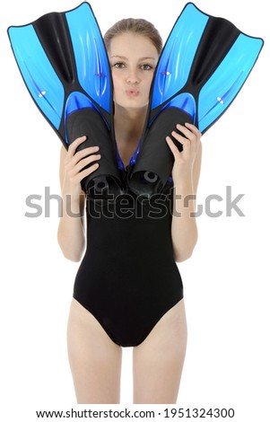 Teenage girl with swim fins wearing a black swimsuit in studio isolated on white