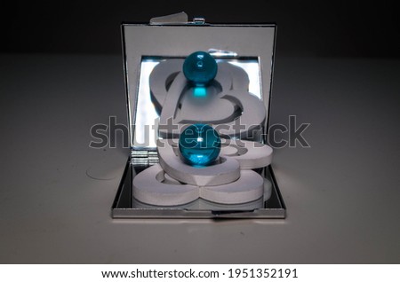 white hearts, ring, glass ball and mirror
