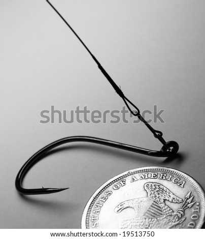The close-up of old one dollar coin and fish hook