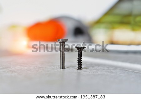 Close up shot steel nail and steel screw black on wooden for construction and maintenance concept