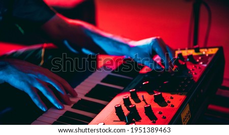 Excited. Close-up of musician performing in neon. Concept of advertising, hobby, music, festival, entertainment. Person improvising inspired. Flyer. Colorful modern, trendy neon lighted, artwork. Royalty-Free Stock Photo #1951389463
