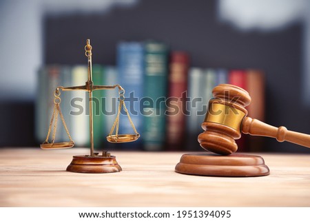 Judge gavel, scales of justice and law books.