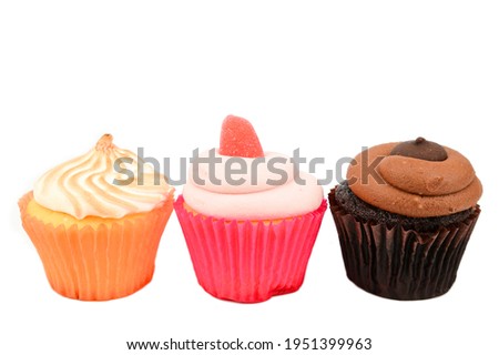 Chocolate, raspberry and lemon cupcakes arranged in a row. Isolated over white background.