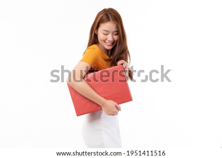 Asian women holding present box. Portrait of happy smiling Asian girl in casual clothing holding gift box isolated on white. Happy pretty Asian woman holding red gift box on white background. 
