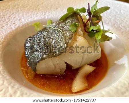 Fine dining, smoked cod served in orange vinaigrette. High quality photo