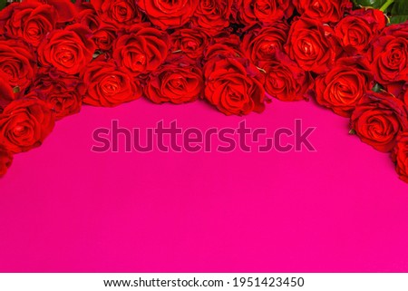Luxurious bouquet of fresh red roses. The festive concept for Weddings, Birthdays, March 8th, Mother's, or Valentine's Day. Greeting card, pink matte background
