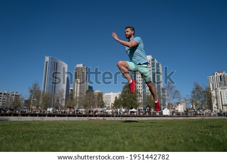 Athletic young man running in the nature.
