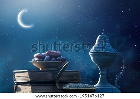 Festive greeting card for Muslim holy month Ramadan Kareem with dates, Quaran, censer and crescent moon.