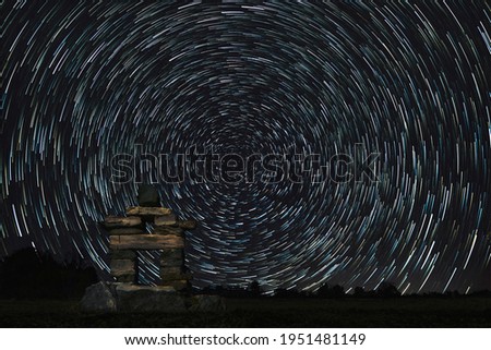 Star Trails over a Stone Inukshuk Statue Royalty-Free Stock Photo #1951481149