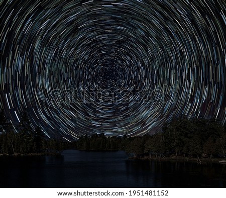 Star Trails over a Lake Royalty-Free Stock Photo #1951481152