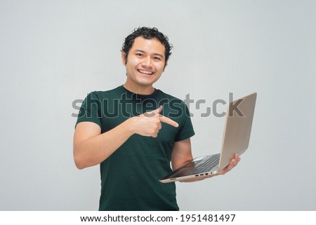 Young hispanic mexican with laptop in arms Royalty-Free Stock Photo #1951481497